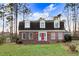 Charming brick home featuring a bright red front door and three dormer windows at 3836 Gloucester Rd, Rocky Mount, NC 27803