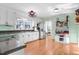 A well-lit kitchen boasts stainless steel appliances, white cabinets, and eat-in breakfast nook at 3836 Gloucester Rd, Rocky Mount, NC 27803