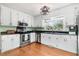 This lovely kitchen features stainless steel appliances, stylish light fixture and white cabinets at 3836 Gloucester Rd, Rocky Mount, NC 27803