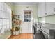 A clean laundry area has stainless steel washer/dryer, storage, and a window to the backyard at 3836 Gloucester Rd, Rocky Mount, NC 27803