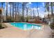 Sparkling in-ground pool in a wooded backyard setting with mature trees at 3836 Gloucester Rd, Rocky Mount, NC 27803