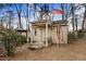 Charming shed with front porch set in a wooded yard, with a flag at 3836 Gloucester Rd, Rocky Mount, NC 27803