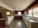 Kitchen with white appliances, wood cabinets, and a peninsula that opens to another room at 4 Second St, Franklinton, NC 27525