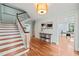 Bright foyer with hardwood floors, white trim, light blue walls, and a staircase at 422 Westwood Dr, Chapel Hill, NC 27516
