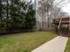 Backyard with lawn is partially fenced, and has a raised deck with access to the home's second level at 426 Fincastle Dr, Cary, NC 27513
