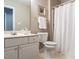 Neutral bathroom featuring a white vanity with elegant fixtures and a shower with a white curtain at 426 Fincastle Dr, Cary, NC 27513