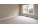 Bright bedroom features a large window, neutral carpet and minimalist decor at 426 Fincastle Dr, Cary, NC 27513