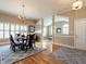 Dining room features hardwood floors, chandelier, rug, and large window at 426 Fincastle Dr, Cary, NC 27513