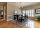 Dining room features hardwood floors, chandelier, rug, and large window at 426 Fincastle Dr, Cary, NC 27513