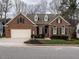 Charming brick home featuring a two-car garage, dormer windows, and well-manicured landscaping at 426 Fincastle Dr, Cary, NC 27513