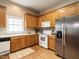Bright kitchen features stainless steel refrigerator, white oven, and ample cabinet space at 426 Fincastle Dr, Cary, NC 27513
