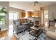 Open-concept living area with hardwood floors, comfortable seating, and kitchen access at 426 Fincastle Dr, Cary, NC 27513