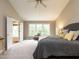 Spacious primary bedroom with large bed, neutral carpet, and a bright window with bench seating at 426 Fincastle Dr, Cary, NC 27513
