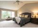 Well-lit primary bedroom with a vaulted ceiling, large bed, and a cozy bench seat by the window at 426 Fincastle Dr, Cary, NC 27513