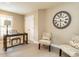 Cozy office space with neutral walls, a large clock and a dark wood desk by the window at 426 Fincastle Dr, Cary, NC 27513