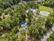 Aerial view of community amenities, showcasing pool, tennis, basketball courts amid lush trees at 498 Mountain Laurel, Chapel Hill, NC 27517