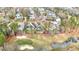 Aerial view of community with a golf course, pond, and beautiful homes at 498 Mountain Laurel, Chapel Hill, NC 27517