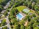Aerial view of community pool, tennis courts, playground and surrounding wooded neighborhood at 498 Mountain Laurel, Chapel Hill, NC 27517