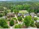 Aerial view showcasing the houses proximity to the golf course and surrounding wooded area at 498 Mountain Laurel, Chapel Hill, NC 27517