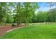 Expansive backyard features a lush lawn bordered by trees, creating a serene and private outdoor space at 498 Mountain Laurel, Chapel Hill, NC 27517