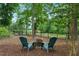 Cozy backyard fire pit area with Adirondack chairs, perfect for outdoor relaxation at 498 Mountain Laurel, Chapel Hill, NC 27517