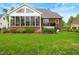 Lush backyard with mature landscaping, a manicured lawn and sunroom at 498 Mountain Laurel, Chapel Hill, NC 27517