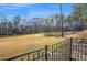 View of a green golf course surrounded by trees, as seen from backyard with metal fence at 498 Mountain Laurel, Chapel Hill, NC 27517