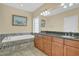 Well-lit bathroom featuring a soaking tub and double vanity, offering a luxurious and functional space at 498 Mountain Laurel, Chapel Hill, NC 27517