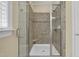 Modern bathroom featuring a glass-enclosed shower with tile surround and built-in bench for a spa-like experience at 498 Mountain Laurel, Chapel Hill, NC 27517