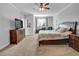 Bedroom features a large window, a ceiling fan, and neutral tones, creating a peaceful atmosphere at 498 Mountain Laurel, Chapel Hill, NC 27517