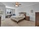 Comfortable bedroom with a ceiling fan, a window with light, and neutral tones creating a restful atmosphere at 498 Mountain Laurel, Chapel Hill, NC 27517
