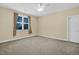 Comfortable bedroom featuring neutral carpet, a ceiling fan and a window that lets in natural light at 498 Mountain Laurel, Chapel Hill, NC 27517