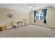 Bright bedroom with natural light, a ceiling fan, and a comfortable chair with an end table at 498 Mountain Laurel, Chapel Hill, NC 27517