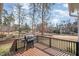 Deck area complete with grill overlooking a lush green golf course and a pond at 498 Mountain Laurel, Chapel Hill, NC 27517