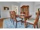 Formal dining room featuring a wooden table, china cabinet, and large window for a sophisticated dining experience at 498 Mountain Laurel, Chapel Hill, NC 27517