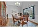Elegant dining room with a large wooden table, chandelier, and window with natural light at 498 Mountain Laurel, Chapel Hill, NC 27517