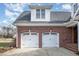 Spacious two-car garage with brick exterior and modern white doors at 498 Mountain Laurel, Chapel Hill, NC 27517