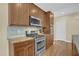 Updated kitchen featuring stainless steel appliances, granite countertops, and wooden cabinetry at 498 Mountain Laurel, Chapel Hill, NC 27517