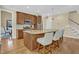 Open kitchen showcasing a large island with counter seating, wooden cabinets, and pendant lighting at 498 Mountain Laurel, Chapel Hill, NC 27517