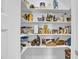 Well-stocked pantry with multiple shelves, providing ample storage in this home at 498 Mountain Laurel, Chapel Hill, NC 27517