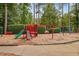 Community playground featuring a slide, swings, and climbing structure, set in a park-like setting at 498 Mountain Laurel, Chapel Hill, NC 27517