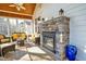 Enclosed sunroom with a stone fireplace, comfortable seating and a view of the outdoors at 498 Mountain Laurel, Chapel Hill, NC 27517