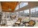 Bright sunroom featuring tile floors, vaulted wood ceiling, large windows, and comfortable wicker seating at 498 Mountain Laurel, Chapel Hill, NC 27517