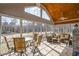 Sunroom with multiple windows, tile floors, ceiling fan, and comfortable furniture at 498 Mountain Laurel, Chapel Hill, NC 27517