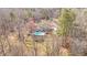 Aerial view showcases a home with a pristine pool and well-manicured grounds surrounded by beautiful mature trees at 520 Log Barn Rd, Pittsboro, NC 27312