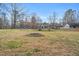 Expansive backyard featuring a fire pit and mature trees, ideal for outdoor gatherings and recreation at 520 Log Barn Rd, Pittsboro, NC 27312