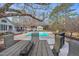 Beautiful backyard features a pool, deck, and outdoor dining area for entertaining at 520 Log Barn Rd, Pittsboro, NC 27312