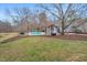Inviting backyard pool with a cozy cabana and lush greenery, perfect for relaxation and outdoor entertainment at 520 Log Barn Rd, Pittsboro, NC 27312
