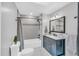 Stylish bathroom featuring a black vanity with marble countertop and tiled shower at 520 Log Barn Rd, Pittsboro, NC 27312