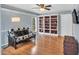 Cozy bedroom featuring built in bookshelves and a view of the yard at 520 Log Barn Rd, Pittsboro, NC 27312
